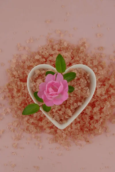 Bath salt with rose extract. Body cosmetics with rose extract.pink sea salt with pink rose flower