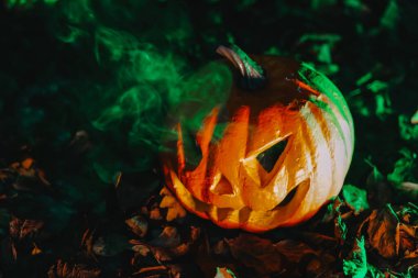 Yeşil Dumanlı Ürkütücü Jack-O-Lantern. Sonbahar bayramı için korkutucu bir süsleme..