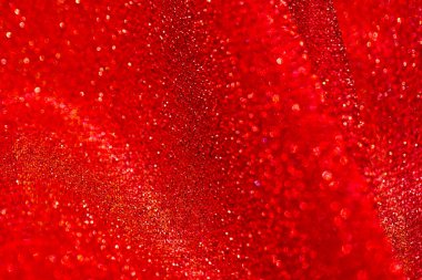  Parlak yanardöner desenli kırmızı parıltılı makro fon. Kırmızı tonlarda parlak kumaş kıvrımları. 