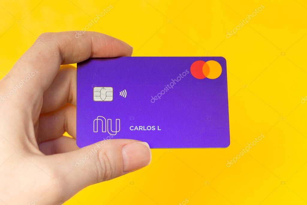 Novo Hamburgo/RS/Brazil - April, 18, 2020. Hand holding a Nubank Creditcard. Nubank is a pioneer Brazilian startup in the financial services segment, acting as a credit card and fintech operator.