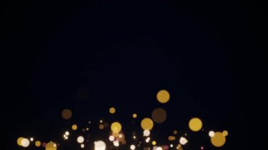 Soyut hareket arkaplanı parlayan altın parçacıkları. Kusursuz 4K döngü video animasyonu