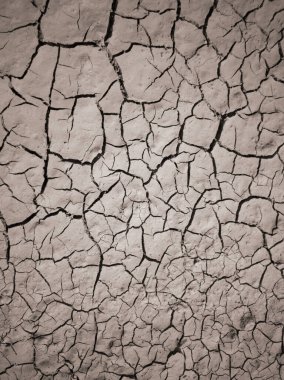 Kuru çatlamış toprak dokusu. Çöl arka planı. Küresel su sıkıntısı. Sıcak iklim ve kuraklığın sembolü olarak kahverengi topraklardaki derin çatlaklar.