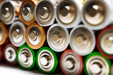 Kullanılmış alkalin pil yığınını kapatın. AA pillerinin renkli satırlarını kapat enerji soyut arkaplanı renkli pillerin.