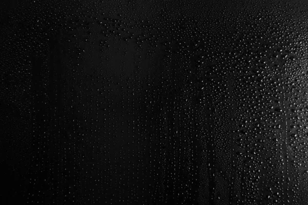 Drops of water on a dark glass texture background