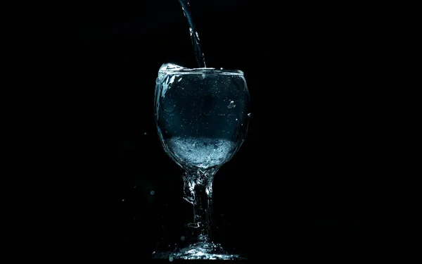 Налейте Воду Стекло Черном Фоне — стоковое фото