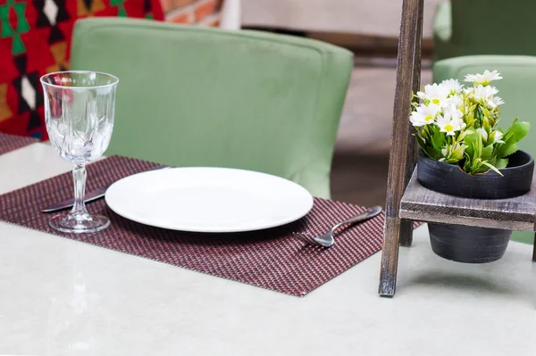 TBILISI, GEORGIA - Restaurant setting table, luxury tableware and dishware on the table. Restaurant interior.
