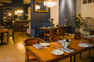 TBILISI, GEORGIA - 12 Eylül 2019: Restoran sehpası, lüks sofra takımı ve bulaşık takımı masada. Restoran içi..