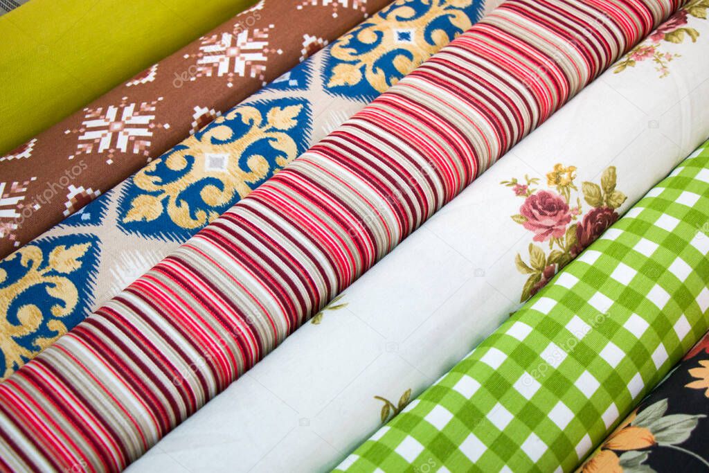 Fabricate silk and cloth on the shop shelf, multicolor and many pattern, rolled silk in the market in Tbilisi, Georgia.