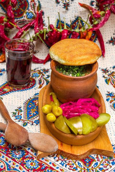 Georgian traditional food Lobio or kidney and haricot beans soup with picked vegetables and red wine. Tbilisi, Georgia.