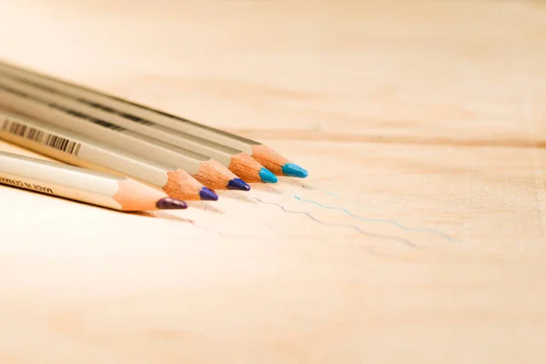 Pencil colors painting instruments on the table, pencil sets. Blue colors.