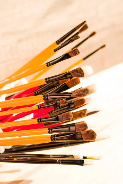 Paint brushes set, close-up. Marketing photo. white background, Studio shot.On the table.