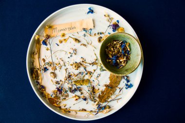 Hafıza sözcük, metin ve mektup eski kağıtta, sonbahar kurutulmuş çiçekler kasede ve mavi masadaki tabakta bitkiler.. .