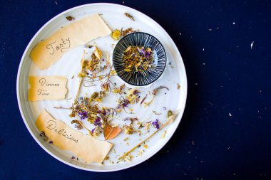 Sonbahar kurutulmuş bitkiler ve mavi arka planda bir çiçek, stüdyo çekimi.