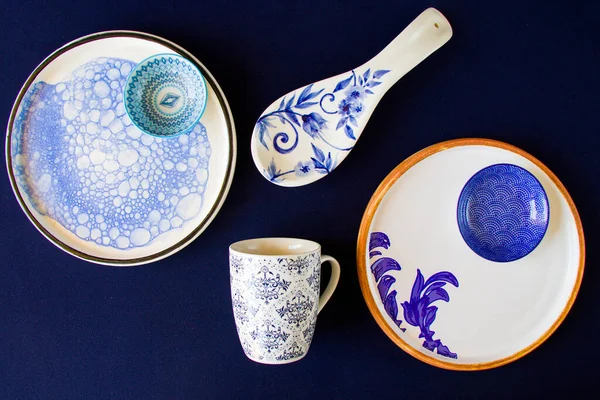 Empty blue tableware, bowl and plate on the blue table. Dish set. Table setting.