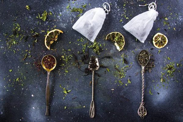 Set of tea on the vintage silverware spoons, various of tea, black, flower, green and mint tea