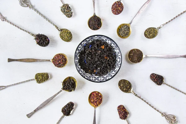 Set of tea on the vintage silverware spoons, various of tea, black, flower, green and mint tea