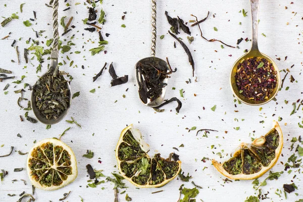 Set of tea on the vintage silverware spoons, various of tea, black, flower, green and mint tea