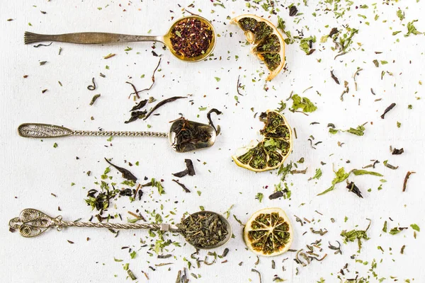 Set of tea on the vintage silverware spoons, various of tea, black, flower, green and mint tea