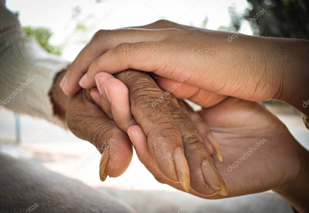 hand of the sick old woman rests on the lap. Mental health care at home.