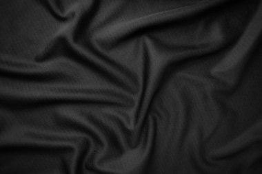Arkaplan dokusu siyah kumaş. Soyut koyu dalgalı yumuşak. Kumaş kırışmış. Lüks moda tarzı..