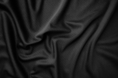 Arkaplan dokusu siyah kumaş. Soyut koyu dalgalı yumuşak. Kumaş kırışmış. Lüks moda tarzı..