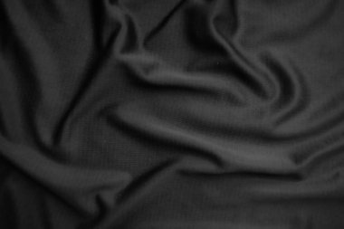 Arkaplan dokusu siyah kumaş. Soyut koyu dalgalı yumuşak. Kumaş kırışmış. Lüks moda tarzı..