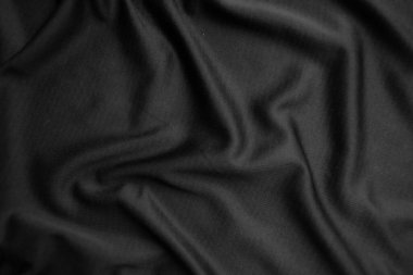 Arkaplan dokusu siyah kumaş. Soyut koyu dalgalı yumuşak. Kumaş kırışmış. Lüks moda tarzı..