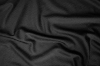Arkaplan dokusu siyah kumaş. Soyut koyu dalgalı yumuşak. Kumaş kırışmış. Lüks moda tarzı..