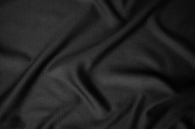 Arkaplan dokusu siyah kumaş. Soyut koyu dalgalı yumuşak. Kumaş kırışmış. Lüks moda tarzı..