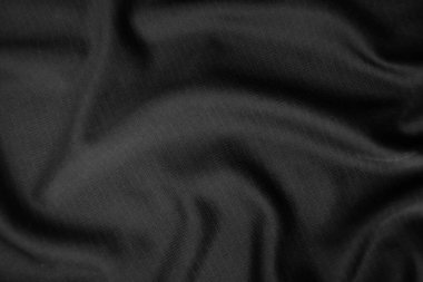 Arkaplan dokusu siyah kumaş. Soyut koyu dalgalı yumuşak. Kumaş kırışmış. Lüks moda tarzı..