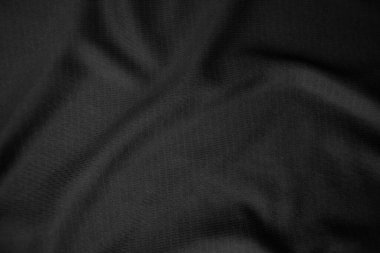 Arkaplan dokusu siyah kumaş. Soyut koyu dalgalı yumuşak. Kumaş kırışmış. Lüks moda tarzı..