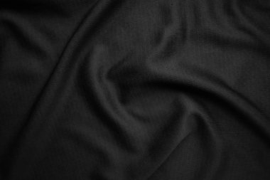 Arkaplan dokusu siyah kumaş. Soyut koyu dalgalı yumuşak. Kumaş kırışmış. Lüks moda tarzı..