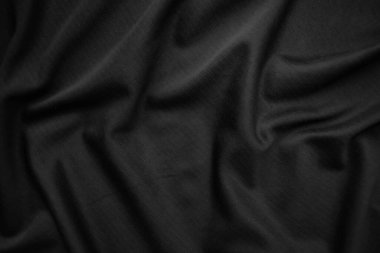 Arkaplan dokusu siyah kumaş. Soyut koyu dalgalı yumuşak. Kumaş kırışmış. Lüks moda tarzı..