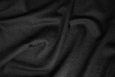 Arkaplan dokusu siyah kumaş. Soyut koyu dalgalı yumuşak. Kumaş kırışmış. Lüks moda tarzı..