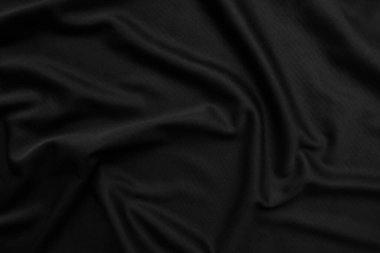 Arkaplan dokusu siyah kumaş. Soyut koyu dalgalı yumuşak. Kumaş kırışmış. Lüks moda tarzı..