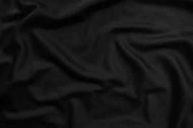 Arkaplan dokusu siyah kumaş. Soyut koyu dalgalı yumuşak. Kumaş kırışmış. Lüks moda tarzı..