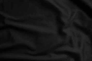 Arkaplan dokusu siyah kumaş. Soyut koyu dalgalı yumuşak. Kumaş kırışmış. Lüks moda tarzı..