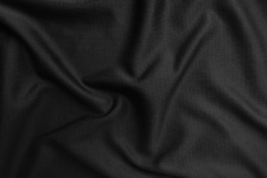 Arkaplan dokusu siyah kumaş. Soyut koyu dalgalı yumuşak. Kumaş kırışmış. Lüks moda tarzı..