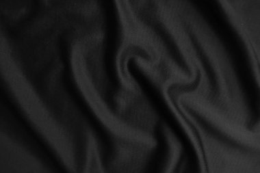 Arkaplan dokusu siyah kumaş. Soyut koyu dalgalı yumuşak. Kumaş kırışmış. Lüks moda tarzı..