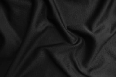 Arkaplan dokusu siyah kumaş. Soyut koyu dalgalı yumuşak. Kumaş kırışmış. Lüks moda tarzı..