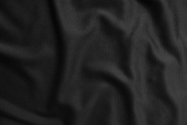 Arkaplan dokusu siyah kumaş. Soyut koyu dalgalı yumuşak. Kumaş kırışmış. Lüks moda tarzı..