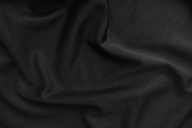 Arkaplan dokusu siyah kumaş. Soyut koyu dalgalı yumuşak. Kumaş kırışmış. Lüks moda tarzı..