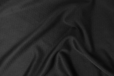 Arkaplan dokusu siyah kumaş. Soyut koyu dalgalı yumuşak. Kumaş kırışmış. Lüks moda tarzı..