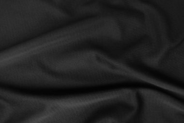 Arkaplan dokusu siyah kumaş. Soyut koyu dalgalı yumuşak. Kumaş kırışmış. Lüks moda tarzı..