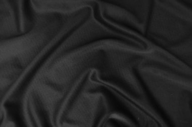 Arkaplan dokusu siyah kumaş. Soyut koyu dalgalı yumuşak. Kumaş kırışmış. Lüks moda tarzı..