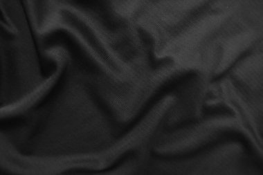 Arkaplan dokusu siyah kumaş. Soyut koyu dalgalı yumuşak. Kumaş kırışmış. Lüks moda tarzı..