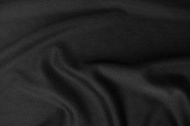 Arkaplan dokusu siyah kumaş. Soyut koyu dalgalı yumuşak. Kumaş kırışmış. Lüks moda tarzı..