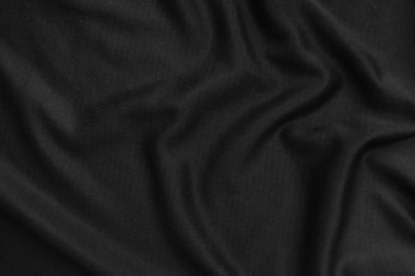 Arkaplan dokusu siyah kumaş. Soyut koyu dalgalı yumuşak. Kumaş kırışmış. Lüks moda tarzı..