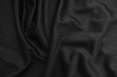 Arkaplan dokusu siyah kumaş. Soyut koyu dalgalı yumuşak. Kumaş kırışmış. Lüks moda tarzı..