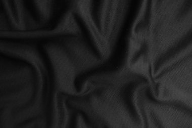 Arkaplan dokusu siyah kumaş. Soyut koyu dalgalı yumuşak. Kumaş kırışmış. Lüks moda tarzı..